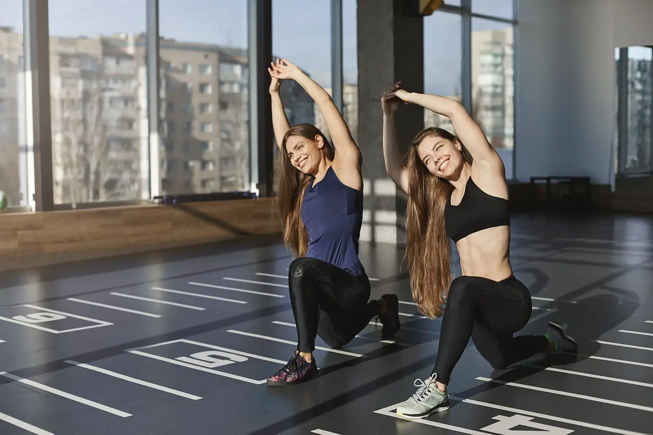 two women doing exercises in a nice looking gym